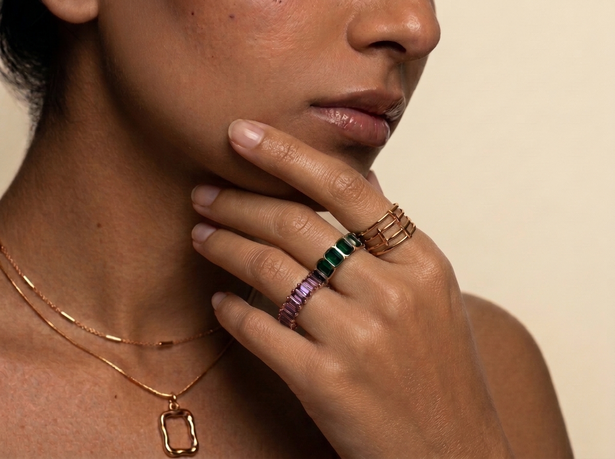 GleamNest Fine Jewelry - Model wearing layered gold necklace and gemstone eternity rings